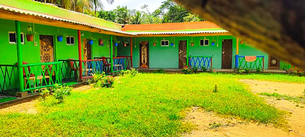 Eco cottages around a green courtyard in daylight