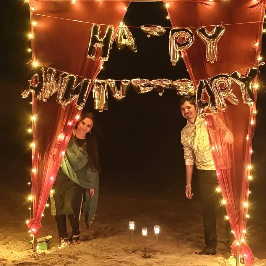Couple under the fairy light anniversary canopy
