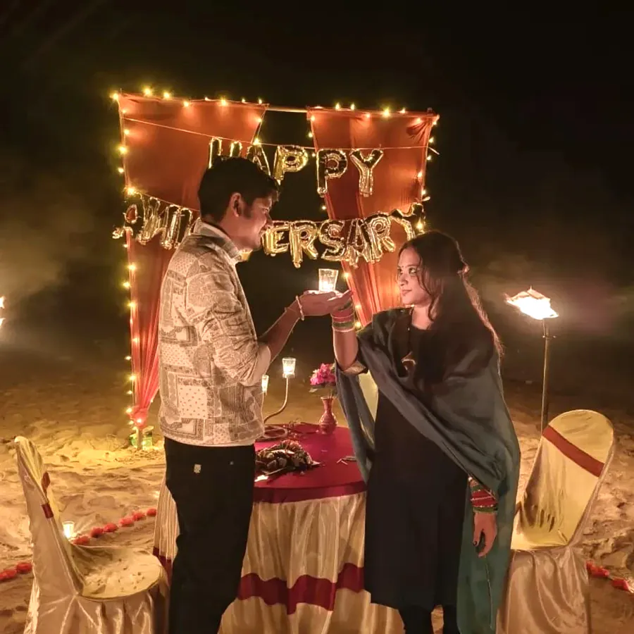 Couple exchanging candle vows at the beach table
