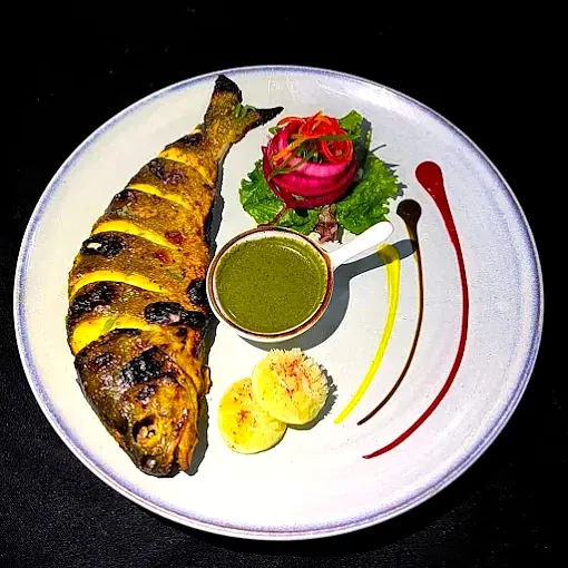 Grilled fish, local coastal food on a styled plate