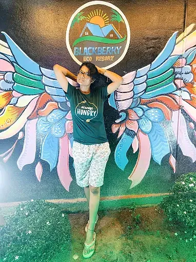 Guest photo in front of the Blackberry mural
