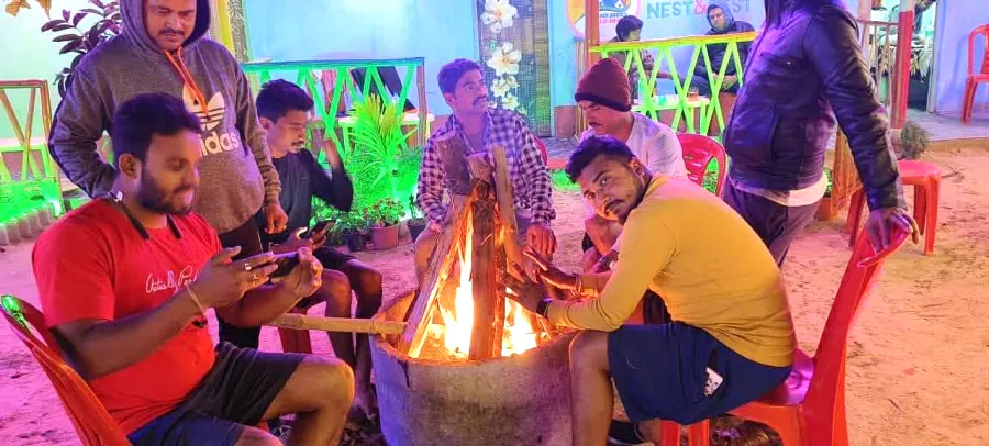 Guests around the bonfire at night