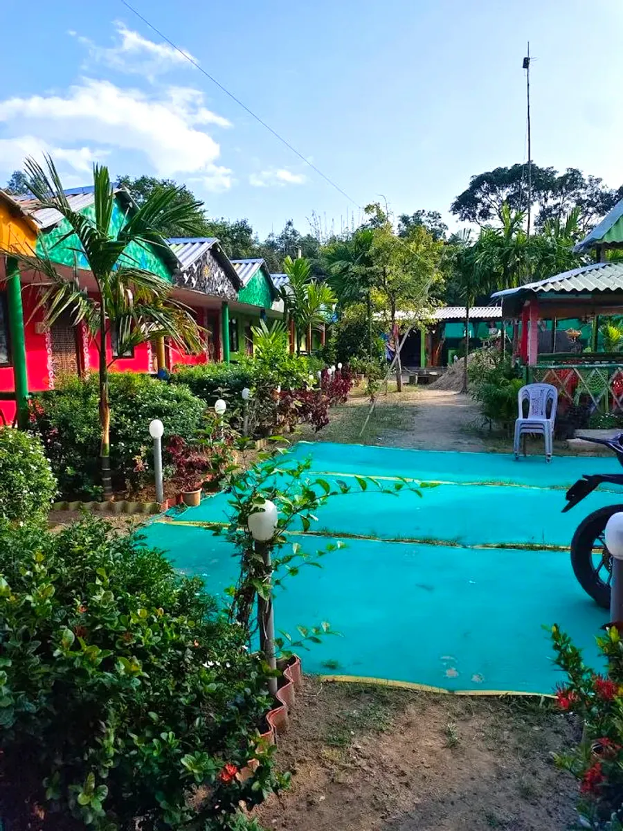Colourful cottages along a garden path in daylight