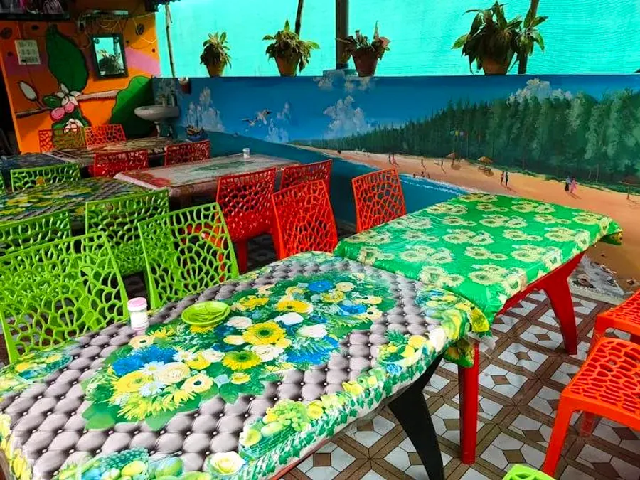 Dining hall with colourful chairs and beach mural