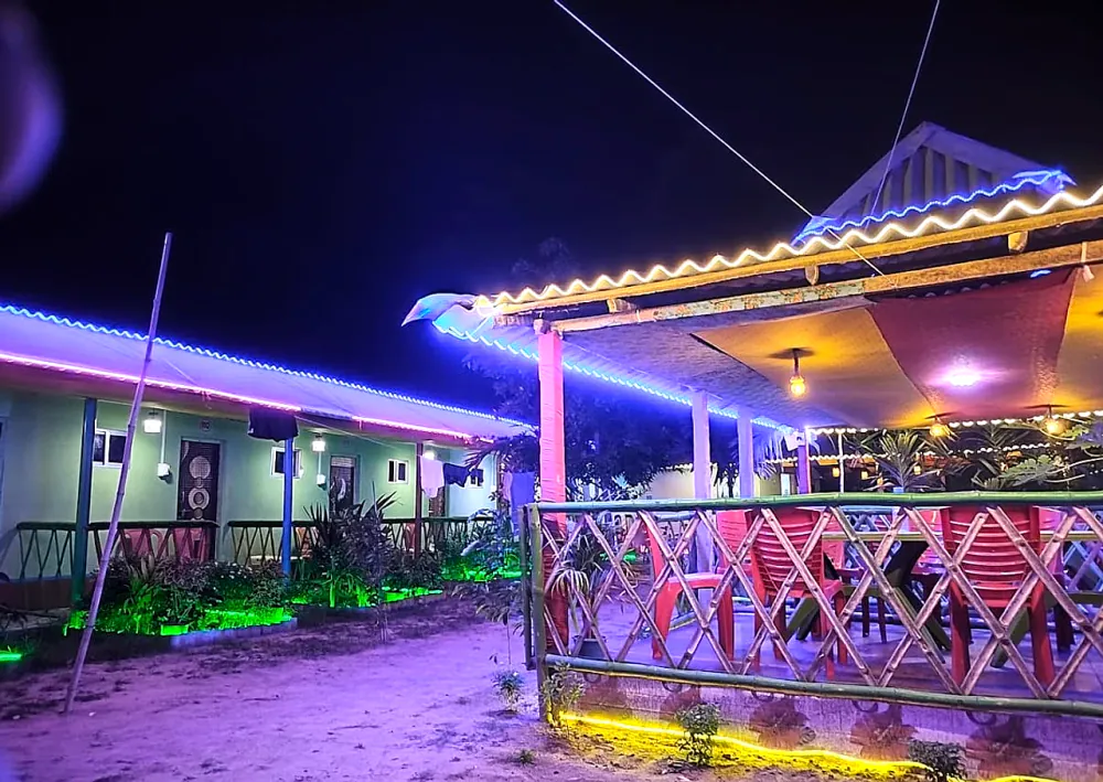 Cottages and dining deck lit up at night