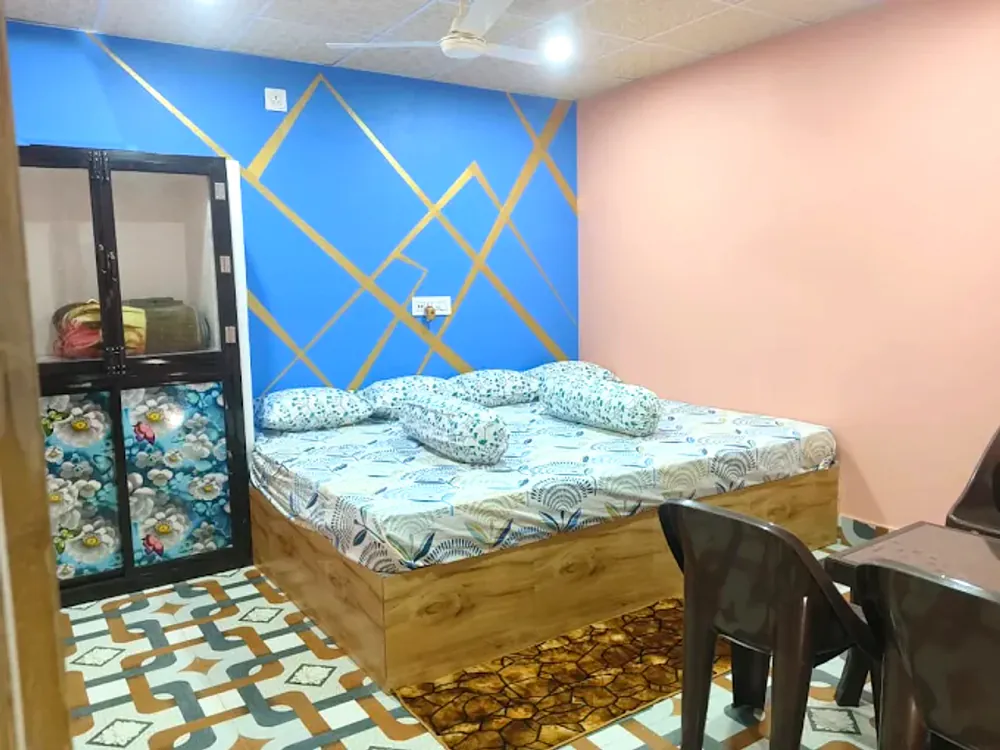 Deluxe room interior with double bed in daylight