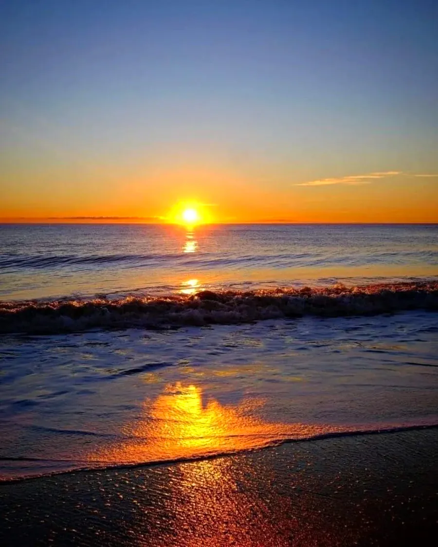 Sun setting over the sea with golden reflection